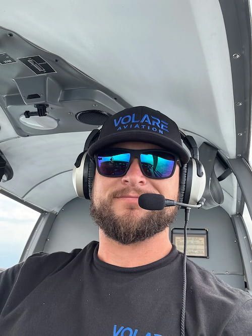Josh Gathright, CFI and CFII, wearing an aviation headset in the cockpit