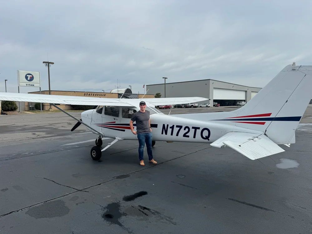 Karl Knipp, founder of Volare Aviation, standing beside a Cessna airplane
